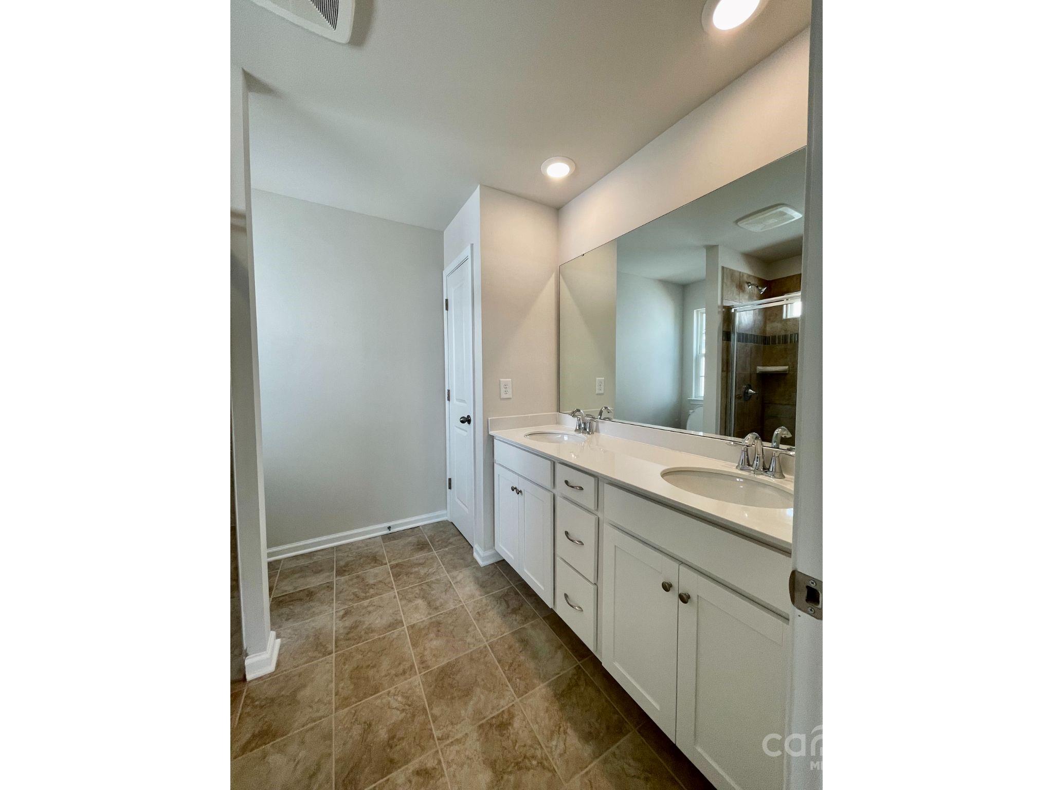 15904 Capps Road Charlotte, NC 28278 - Photo 8 of 21 a spacious bathroom with a double vanity sink and a mirror
