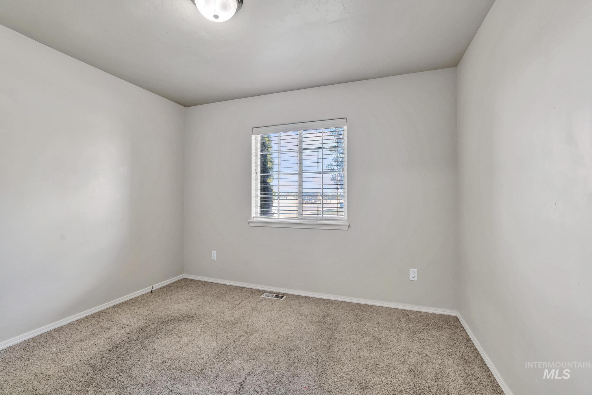 446 Noble Street Twin Falls, ID 83301 - Photo 16 of 42 Neutral-toned wall finishes with a window featuring horizontal blinds