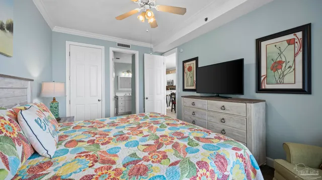 a bedroom with a bed and a flat screen tv in it