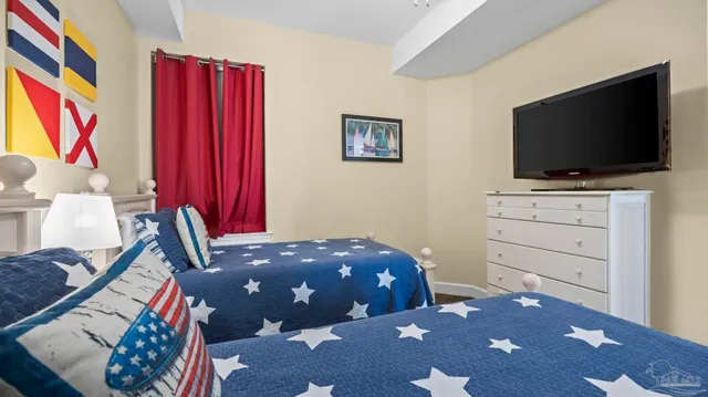 a bedroom with a bed and a flat screen tv