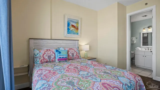 a bedroom with a bed and painting on the wall