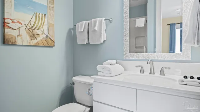 a bathroom with a sink mirror and vanity