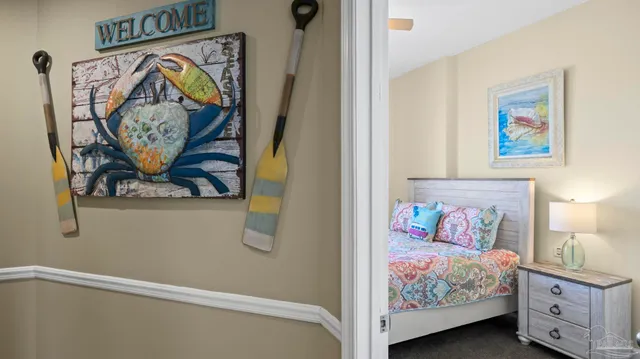 a bedroom with a bed and painting on the wall