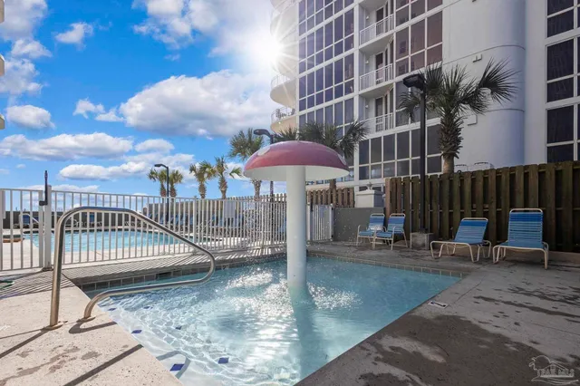a view of a swimming pool with a yard