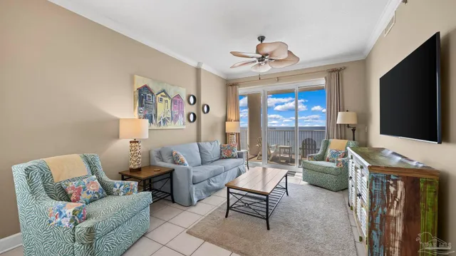 a living room with furniture a flat screen tv and a large window