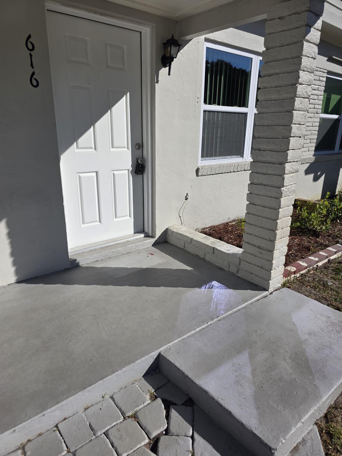 a front view of a house with stairs