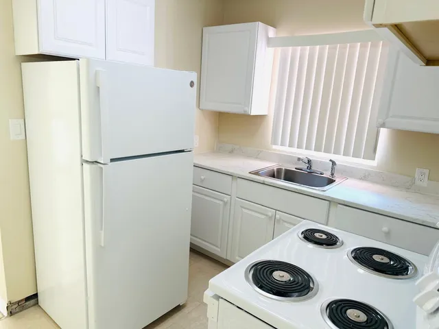 a white refrigerator freezer sitting in a kitchen