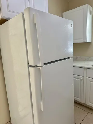 a white refrigerator freezer sitting in a kitchen