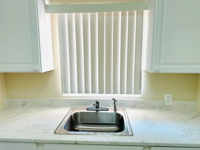 a bathroom with a sink and a window