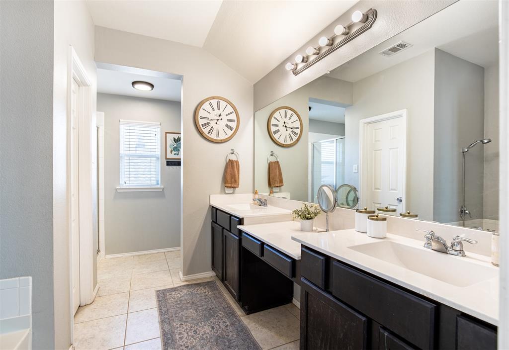416 Allbright Road Celina, TX 75009 - Photo 21 of 40 a bathroom with a double vanity sink and a mirror