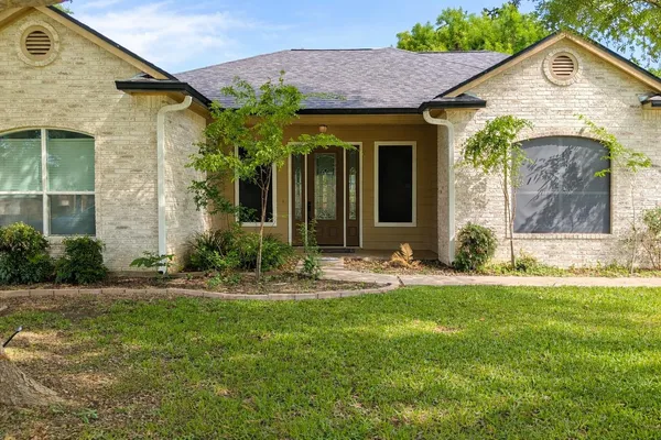 an aerial view of a houses with a yard
