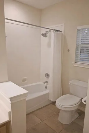 a bathroom with a toilet and shower