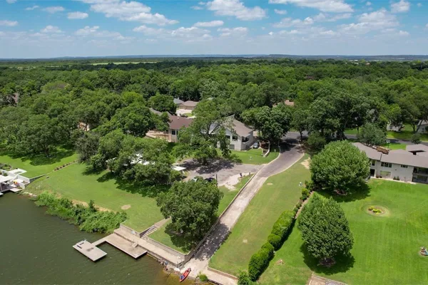 an aerial view of a houses with a yard