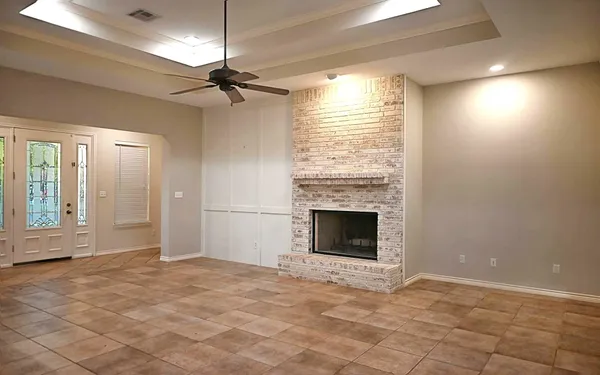 a view of empty room with a fireplace and fan