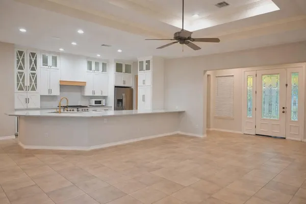 a view of kitchen with granite countertop cabinets and window