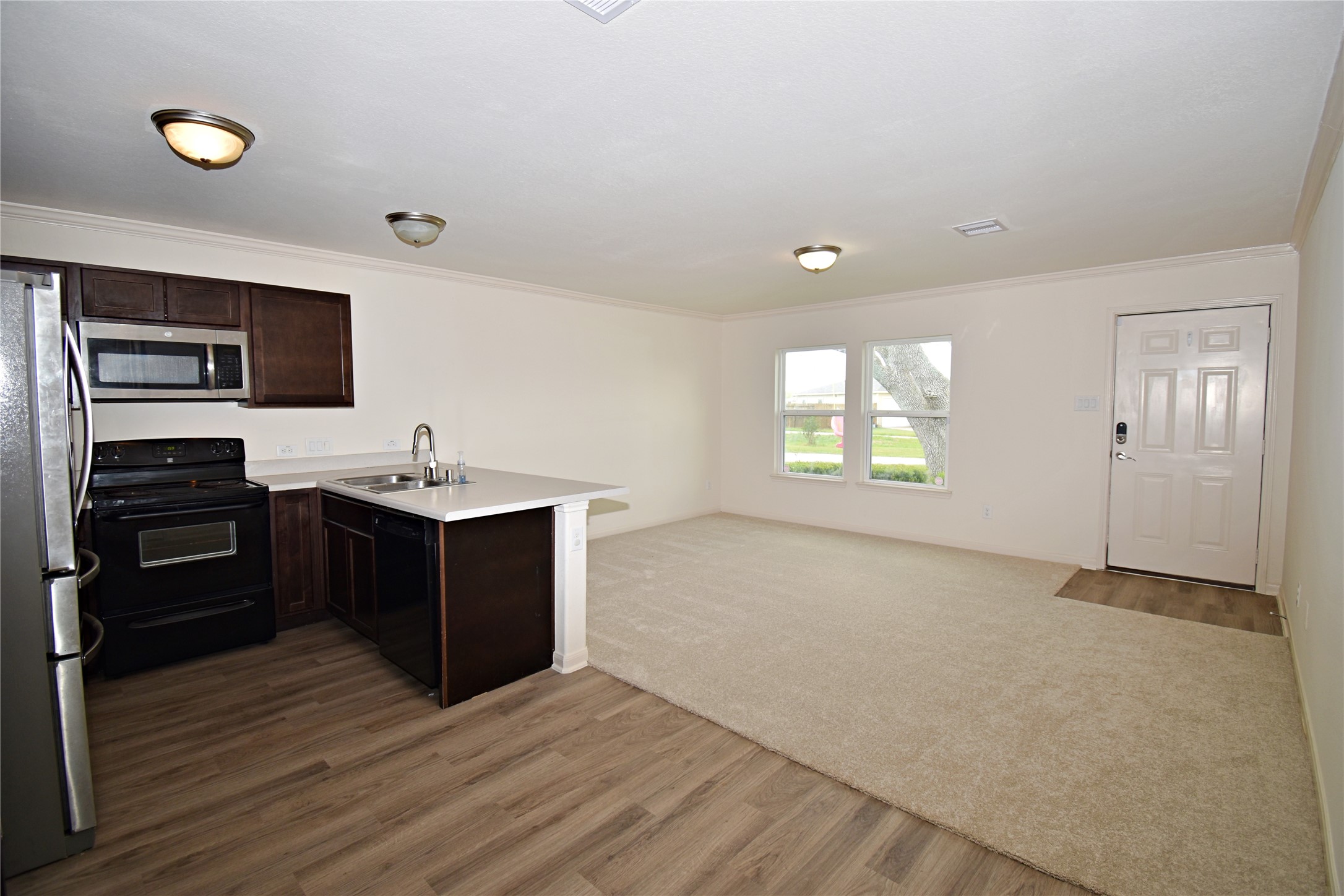 106 Collins Court Kendleton, TX 77451 - Photo 4 of 13 a view of a kitchen with a sink oven dryer and washer