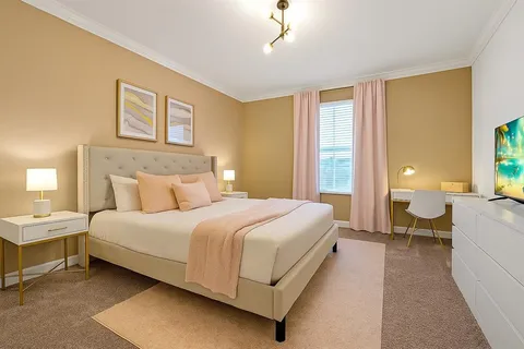 a bathroom with a granite countertop sink a large mirror and tub