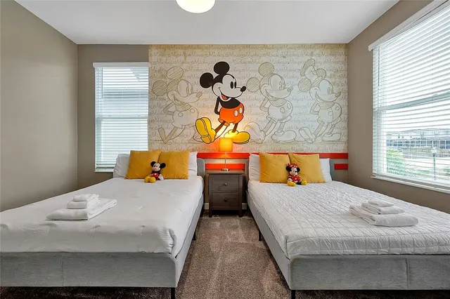 a spacious bedroom with a bed and a chandelier