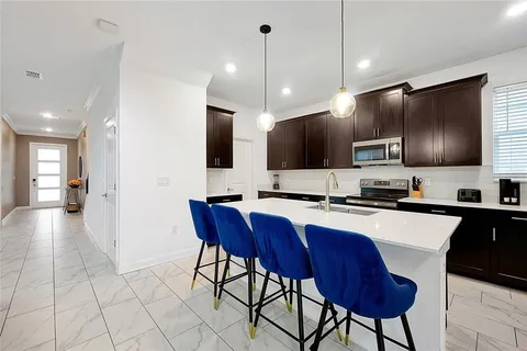 a view of a house with pool table and chairs
