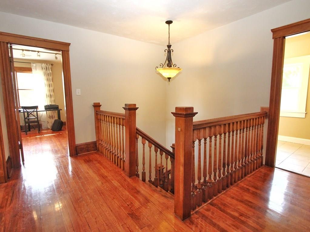 4 Ashmore Road Worcester, MA 01602 - Photo 20 of 38 a view of a hallway with wooden floor and stairs