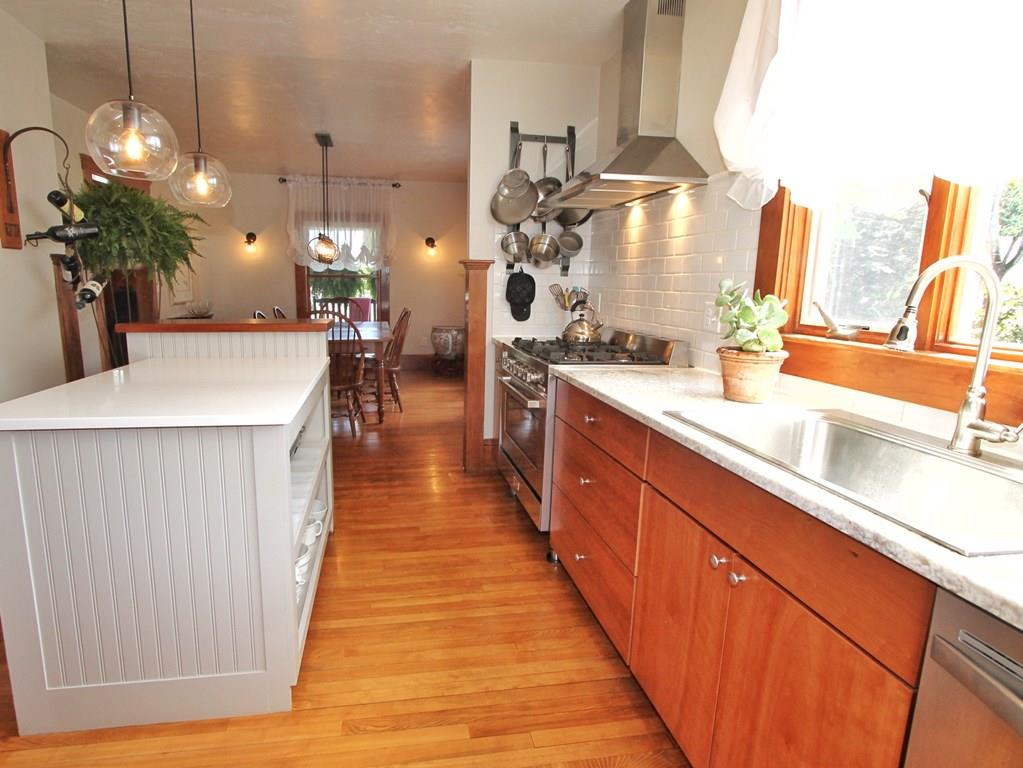 4 Ashmore Road Worcester, MA 01602 - Photo 10 of 38 a large kitchen with kitchen island a counter space a sink and living room view