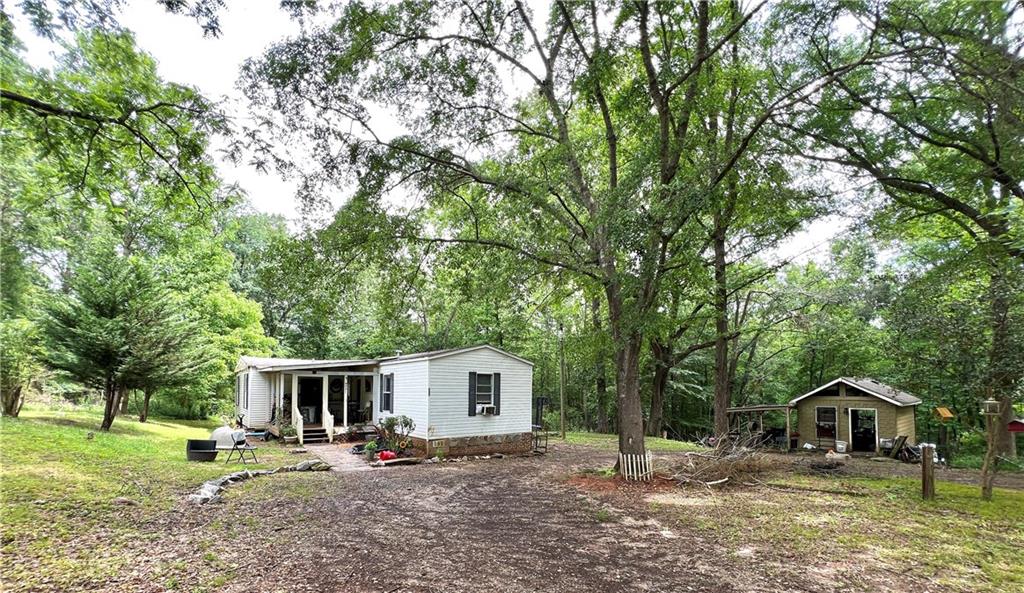 202 Crocker Road Alto, GA 30510 - Photo 1 of 1 a house with trees in the background