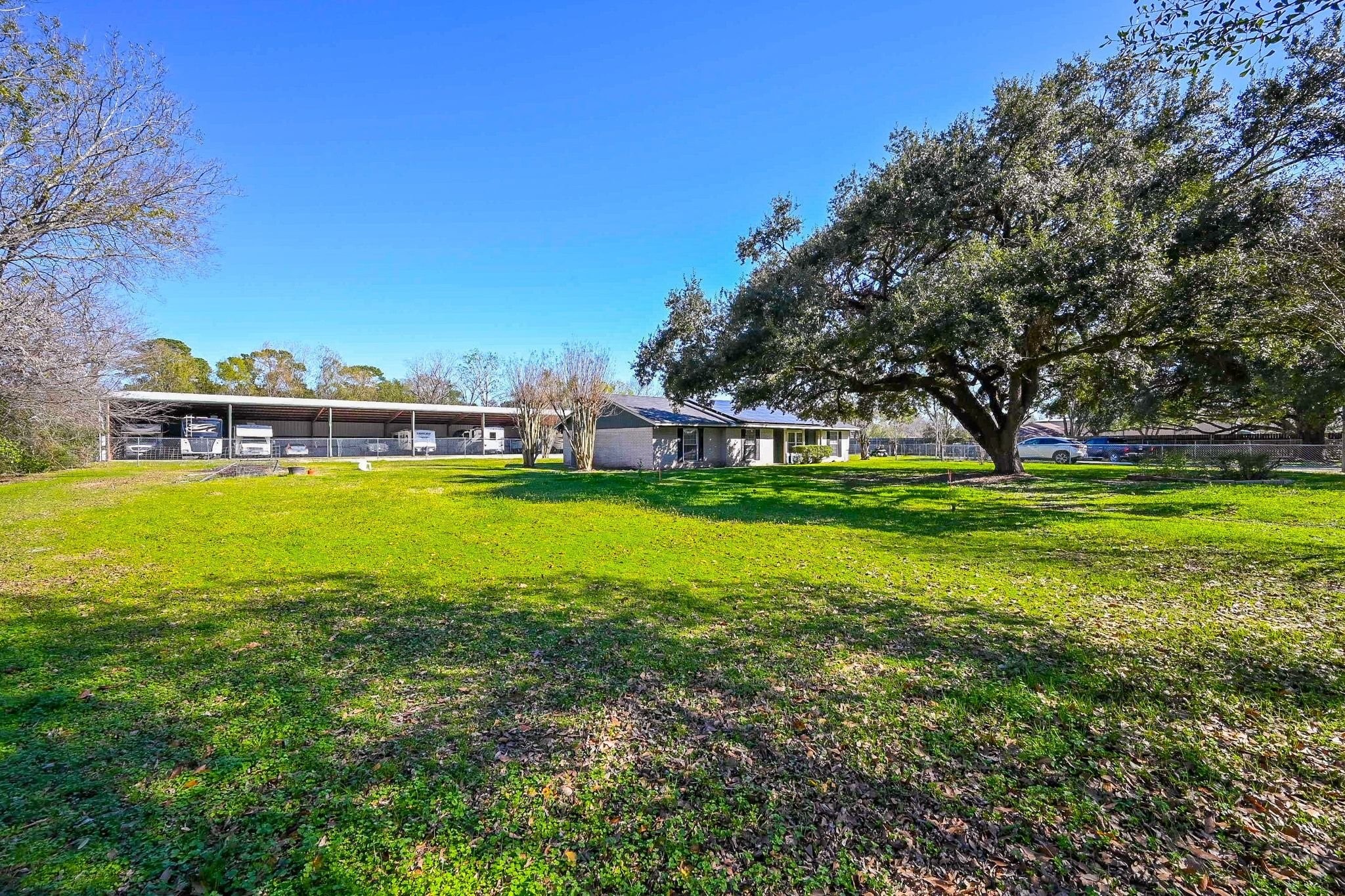 18910 Carrot Street Spring, TX 77379 - Photo 19 of 48 a view of a house with a big yard and large trees