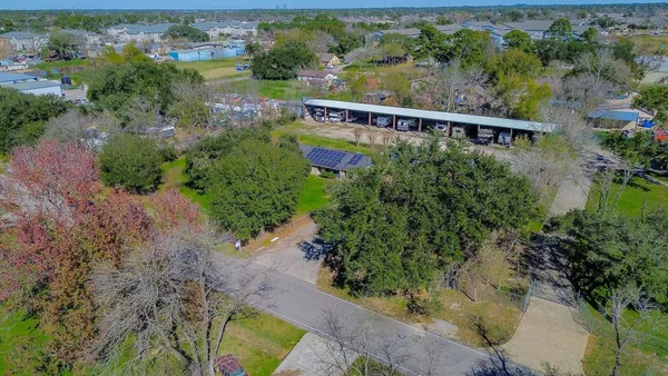 an aerial view of a house with a yard and lake view