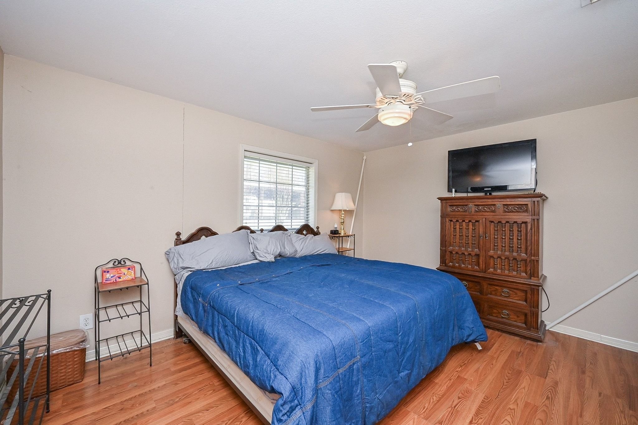 18910 Carrot Street Spring, TX 77379 - Photo 34 of 48 a bedroom with a bed and a flat screen tv on dresser