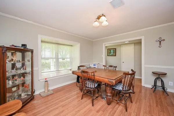a living room with furniture a couch and wooden floor