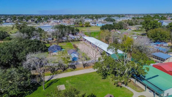 an aerial view of residential houses with outdoor space and lake view