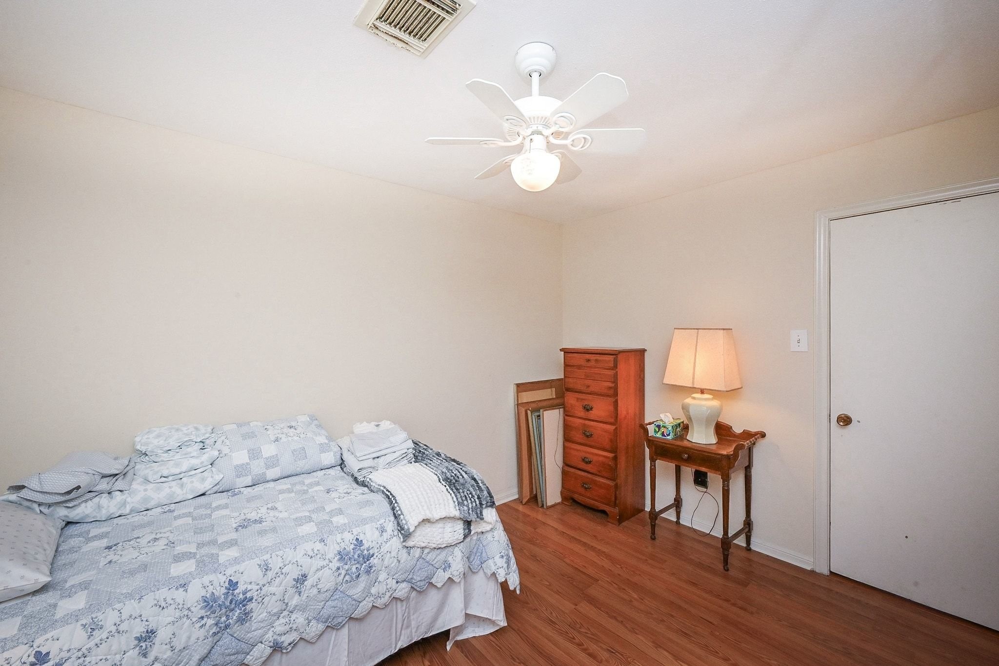 18910 Carrot Street Spring, TX 77379 - Photo 47 of 48 a bedroom with a bed and wooden floor