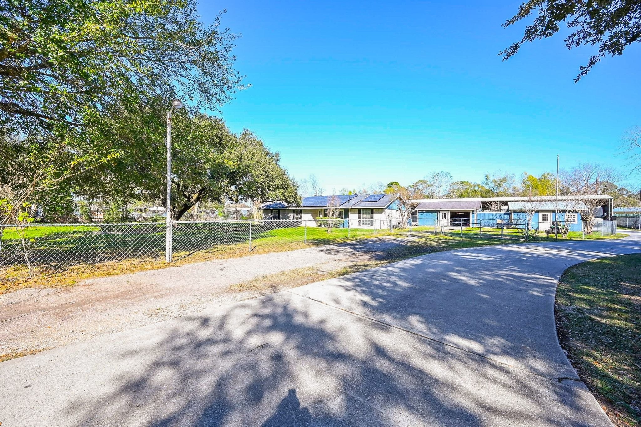 18910 Carrot Street Spring, TX 77379 - Photo 48 of 48 a view of a swimming pool with lawn chairs and large trees