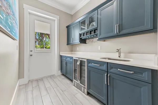 a kitchen with stainless steel appliances granite countertop a sink and cabinets with wooden floor