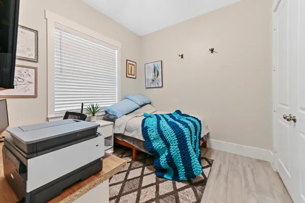 a bedroom with a bed and a chair