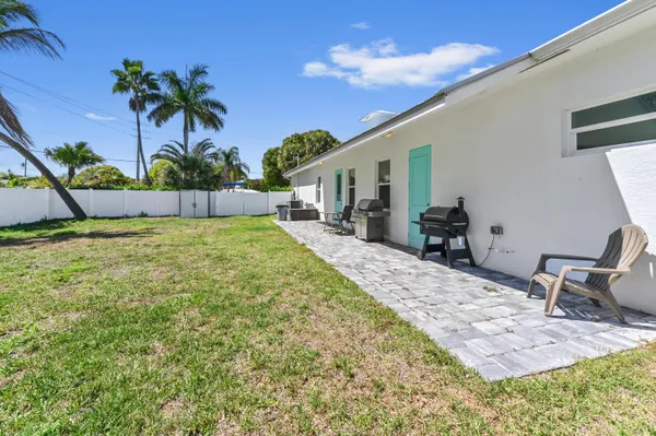 a swimming pool with outdoor seating and yard