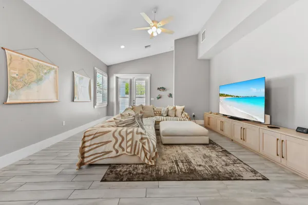 a bedroom with furniture and a flat screen tv