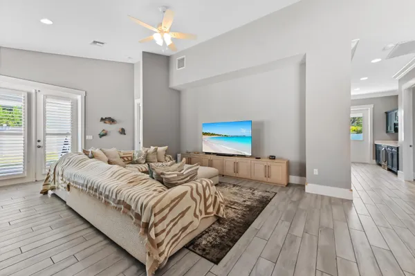 a spacious bedroom with a bed and a chandelier