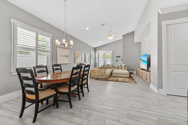 a view of a dining room with furniture and a potted plant