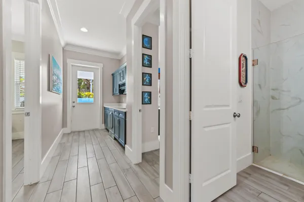 a view of a hallway with wooden floor and staircase