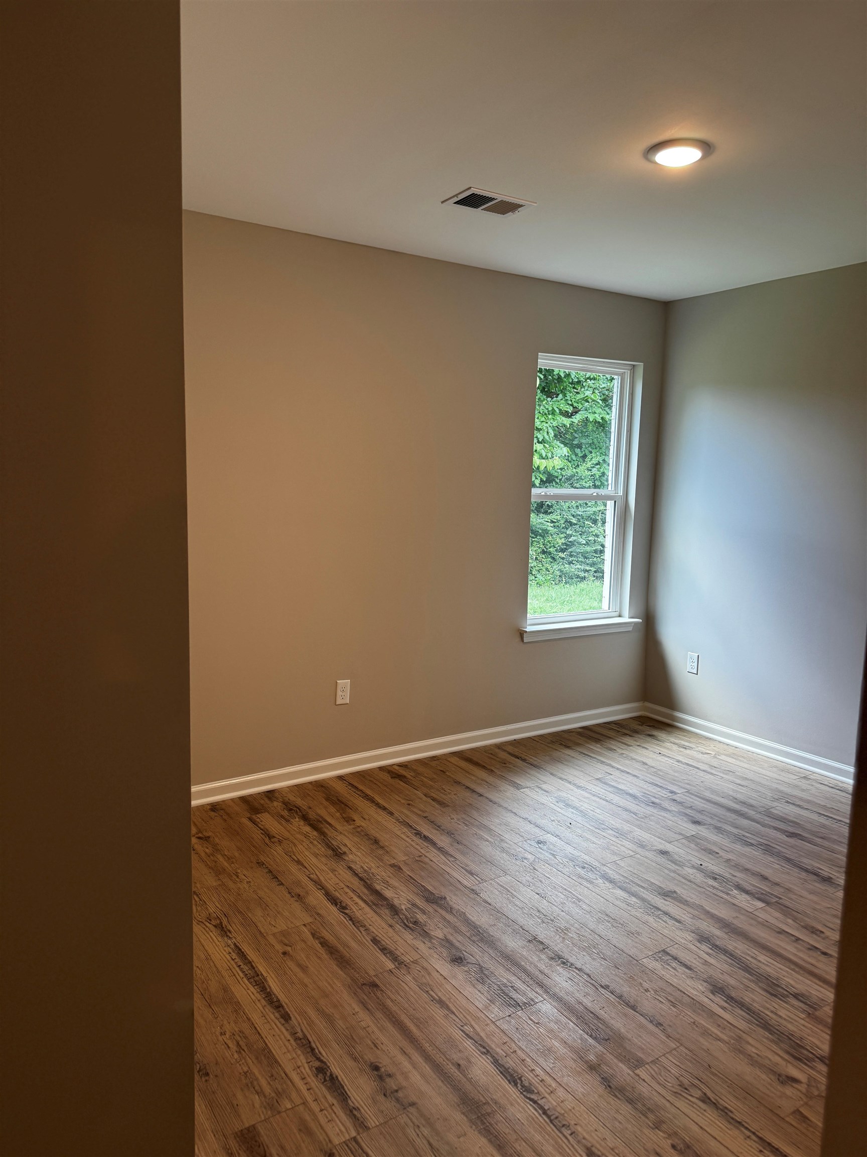 5283 Zodiac Road Memphis, TN 38118 - Photo 9 of 13 Room with wood-finish flooring, neutral wall paint, and white baseboards