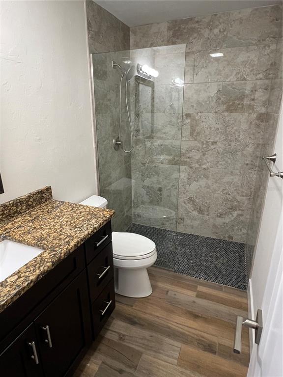 511 West Retta Esplanade Punta Gorda, FL 33950 - Photo 16 of 19 a bathroom with a granite countertop sink toilet and shower