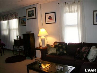 835 Spring Street Bethlehem, PA 18018 - Photo 3 of 12 a living room with furniture a lamp a rug and a window