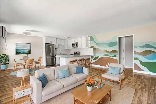 a living room with furniture and kitchen view