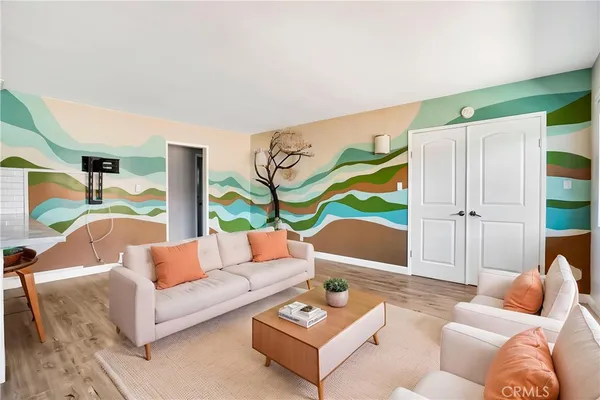 a living room with furniture and a floor to ceiling window