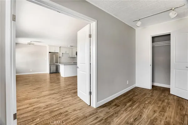 a view of an empty room with wooden floor
