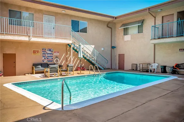 a view of a patio with table and chairs under an umbrella