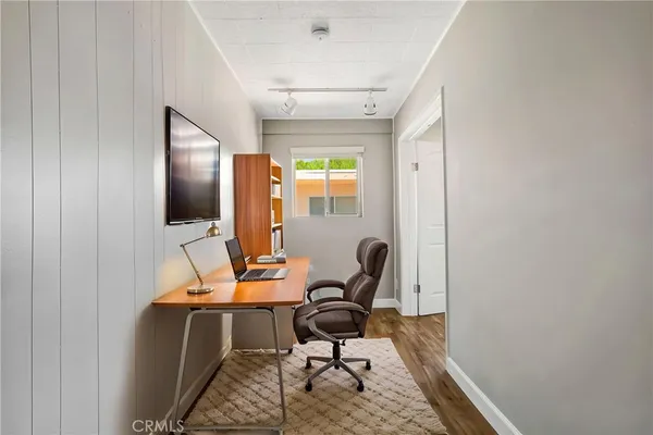 a view of a workspace with furniture and a window