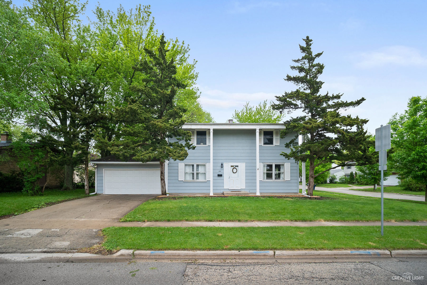 a front view of a house with a yard and a garage