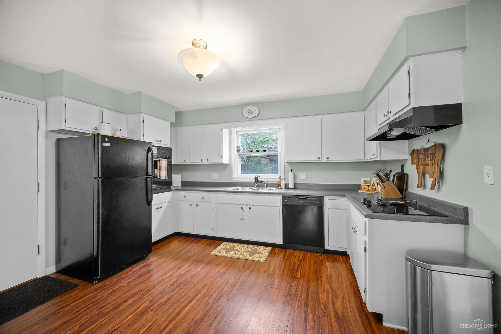800 Russell Road DeKalb, IL 60115 - Photo 7 of 19 a kitchen with granite countertop a refrigerator stove top oven and sink